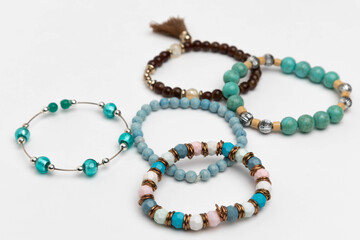 Studio photo of five beaded bracelets. 