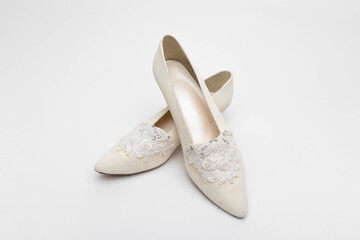 Studio photo of a pair of women's vintage shoes. The background is white.