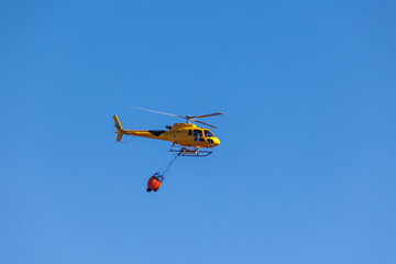 Helicopter flying with the fire bag