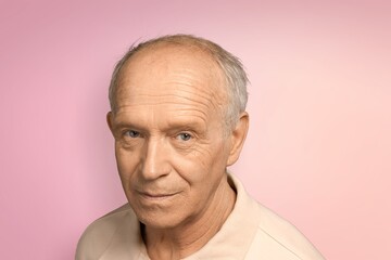 Nice old grey man posing on the color background