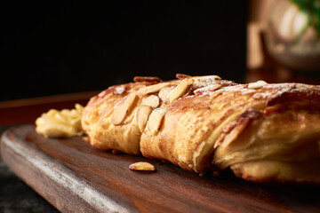 French artisan bread, almond tie name bread placed on a wood and almonds to the side