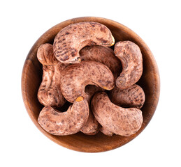 Cashew nuts in shell in wooden bowl, isolated on white background. Roasted and salted cashew nuts. Top view.