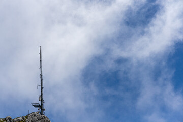 radio antenna tower under blue sky on a mountain