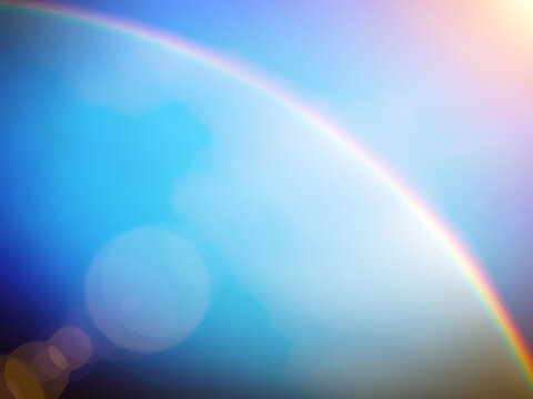 Blue rainbow light effect background. Bright blue background image with a rainbow blurred pattern.