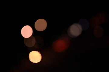 orange bokeh light circles on black background