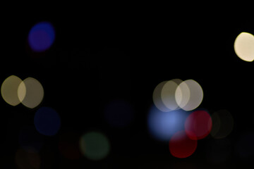 blue bokeh light circles on black background