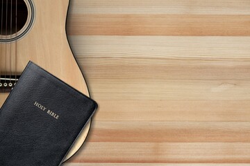 Holy Bible with acoustic guitar, gospel music concept