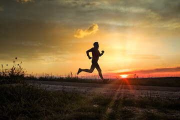 active man silhouette running at sunset