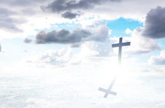 Image of silhouette of Christian cross over clouds against sky in the background. Easter religion faith concept