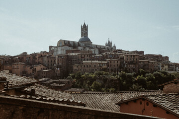 Beautiful view over the rooftops and romantic city of Sienna tuscany to the Dome and Cathedral of Sienna.