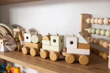 A shelf with children's wooden toys in the children's room. Children's concept