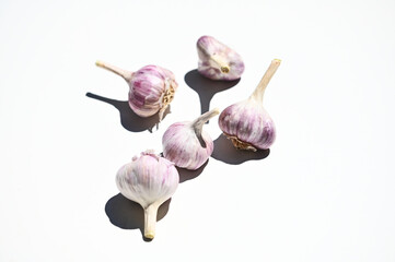 Close-up. Group of Garlic clove and bulbs isolated on white background with copy space. Horizontal studio shot. Flat lay