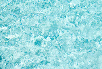 turquoise color backdrop of swimming pool water with ripples in summer
