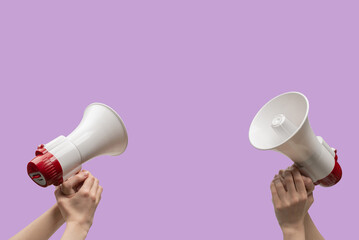 Megaphone in woman hands on a purple background.