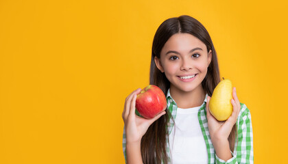 Fototapeta na wymiar happy kid with apple and pear on yellow background