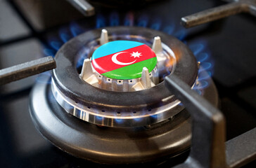 A burning gas burner of a home stove, in the middle of which a flag is depicted - Azerbaijan