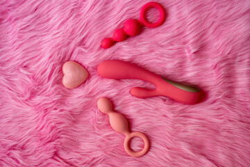 sex toys on pink background, love heart