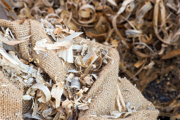Wood shavings bag, hand craft. Shavings after the work of a carpenter with a planer, closeup