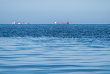 Cargo ships at sea on a sunny summer day.