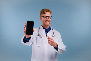 Male on-line doctor man show screen on mobile phone isolated on blue background.