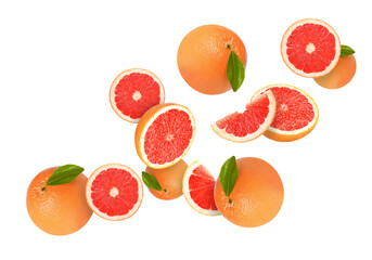 Tasty ripe grapefruits and green leaves falling on white background