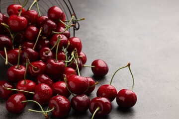 Many sweet cherries on grey table, space for text