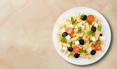 Vegetarian salad with leaves, cherry tomatoes in a plate on the table.