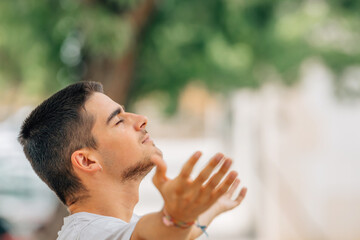 young man breathing relaxed outdoors