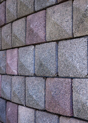 Red, tan, and Gray Brick Stone Wall Side View Background.
