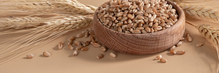 Ears of wheat and bowl of wheat grains