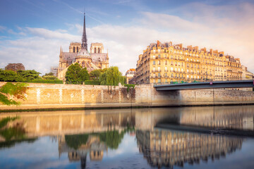 Notre Dame of Paris on Seine River reflection at peaceful sunrise, France