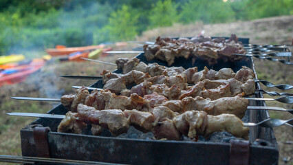 Selective focus. Cooking barbecue on the mangal in nature. Grilled tasty meet cooking on the party