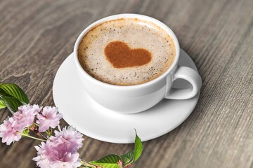 Spring composition with coffee and blooming flowers on the desk