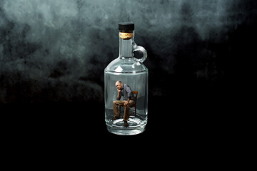 Man trapped in an empty bottle, sitting on a chair