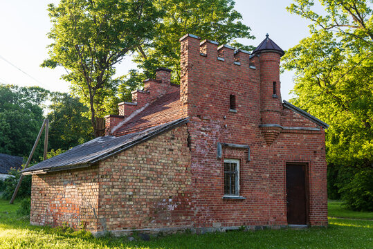 Mound red brick gatekeeper's house. It looks like a small castle. Lasi, Latvia.