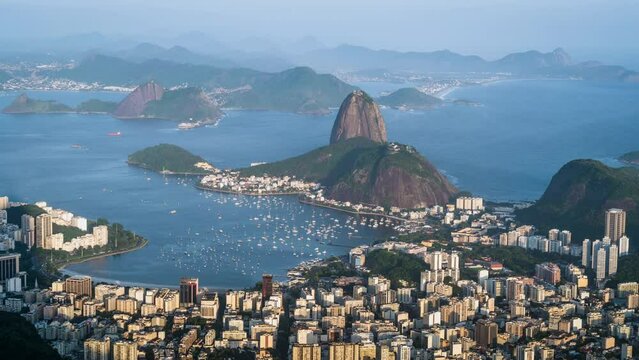 Zoom out time lapse view Sugarloaf mountain and Rio cityscape during summer in Rio de Janeiro, Brazil. 
