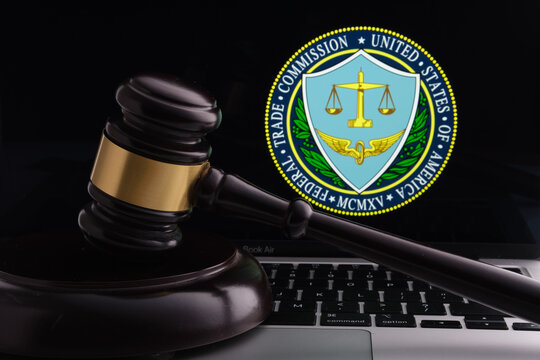 Court hammer placed on laptop with blurred FTC Federal Trade Comission logo on the screen. Concept. Stafford, United Kingdom, July 27, 2022