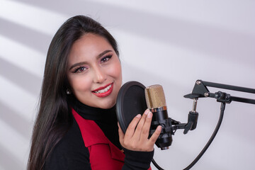 Hispanic podcast broadcaster performing a live broadcast, podcast creation concept, isolated on white background with copy space.