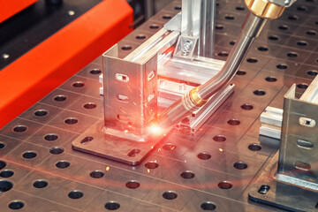 Industrial welding. CNC welding machine welds metal parts. Automatic welding of steel parts....