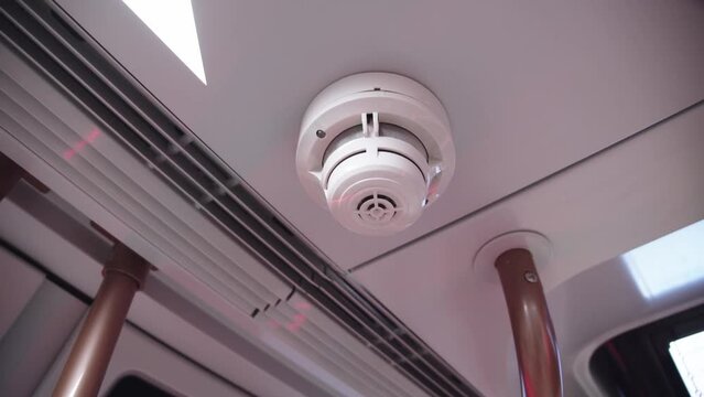 Close-up of smoke alarm on the ceiling of subway car. Fire security alarm in the metro car. train wagon interior.