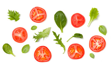 Creative layout made of tomato slices and lettuce salad leaves. Flat lay, top view. Food concept. Vegetables isolated on white background. Food ingredients pattern.
