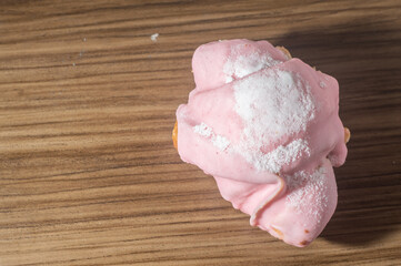 Croissant with strawberry topping and filling with sweet milk