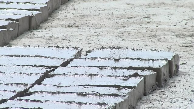 Man Making Adobe Bricks as a Building Material, typically in the form of Sun-dried Bricks made from Earth and Organic Materials, Santiago del Estero, Argentina. Close Up.  