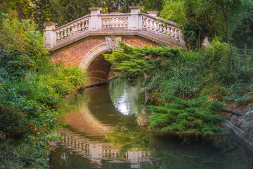 Bridge above pond with reflection in Parc Monceau, Paris, France