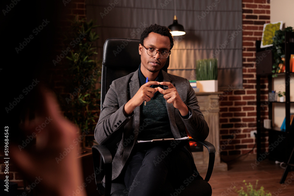 Wall mural African american therapist doing psychoanalysis consultation with couple at therapy session. Giving relationship advice to solve conflict between angry partners, counseling support.