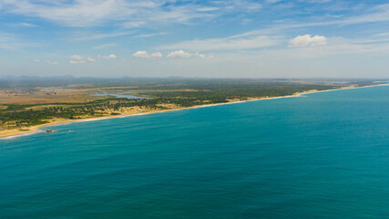 Aerial view of landscape of the island of Sri Lanka with beaches, ocean and agricultural land.