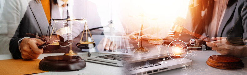 Fototapeta premium Justice and law concept.Male judge in a courtroom with the gavel, working with, computer and docking keyboard, eyeglasses, on table in morning light