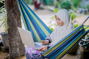  muslim girl homework in the garden