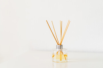 Spa therapy, aromatherapy. Diffuser bottle on a white background. Incense sticks for the home with a floral scent. The concept of eco-friendly fragrance for the home
