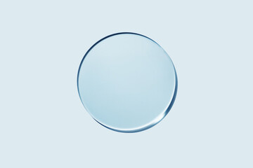 Empty round petri dish or glass slide on blue background. Mockup for cosmetic or scientific product...